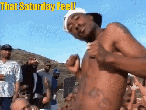 a shirtless man is dancing in front of a crowd with the words that saturday feel written above him