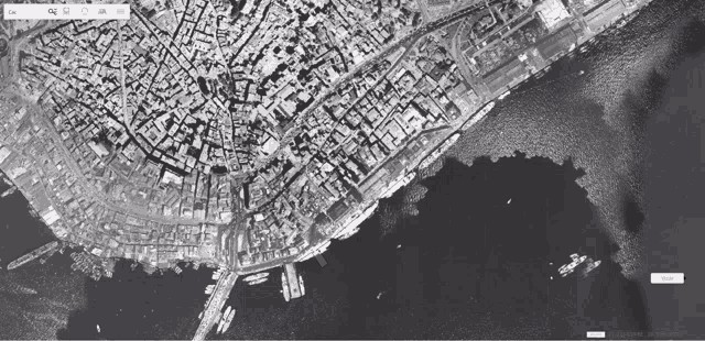 an aerial view of a city and a body of water is shown on a computer screen