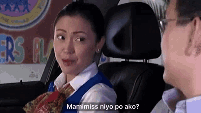 a man and a woman are sitting in a car and the woman is asking the man " mamimiss niyo po ako ? "
