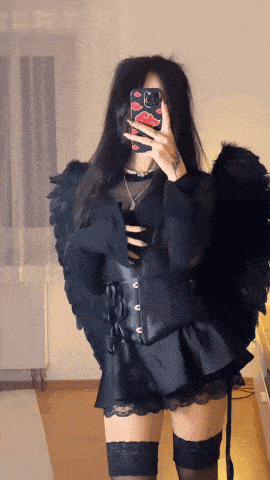 a woman taking a picture of herself with a cell phone