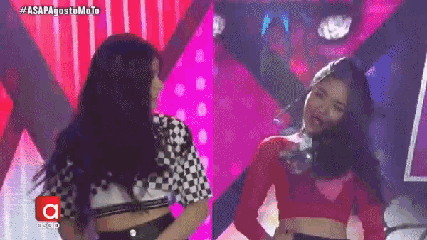 two women are standing next to each other on a stage in front of a sign that says asap