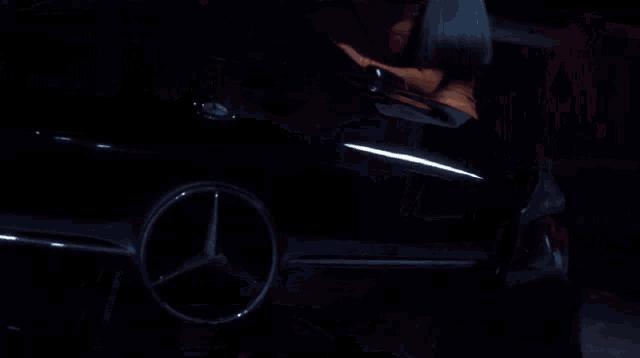 a woman in a brown dress is opening the door of a car .