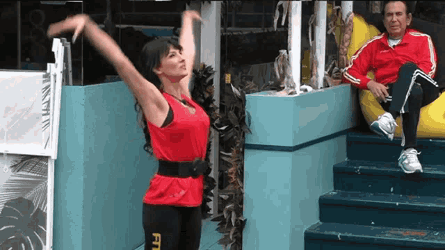 a woman in a red top with the word fit on her leggings