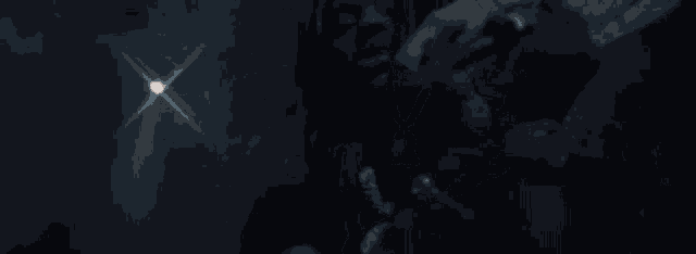 a blurred image of a man with long hair and a beard