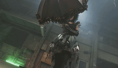 a woman in a gothic dress is holding an umbrella in a dark room