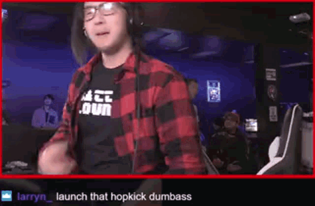 a man wearing glasses and a plaid shirt says " launch that hopkick dumb ass "