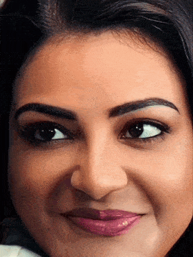 a close up of a woman 's face with a purple lip