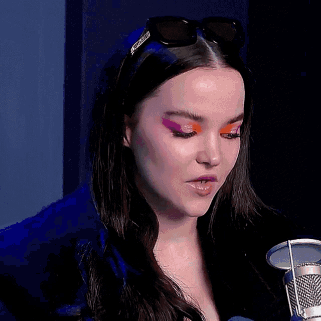 a close up of a woman wearing sunglasses and a headband that says gucci