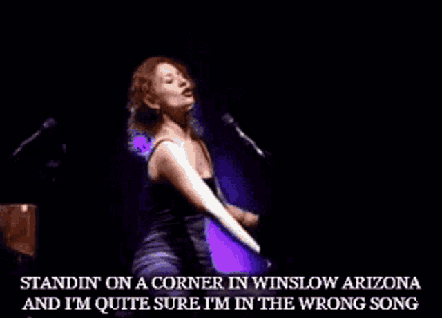 a woman is standing on a corner in winslow arizona and is quite sure she is in the wrong song