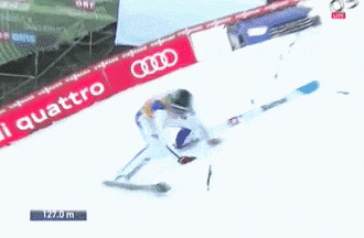 a person is skiing down a snowy slope with a sign that says 127.0 m on it