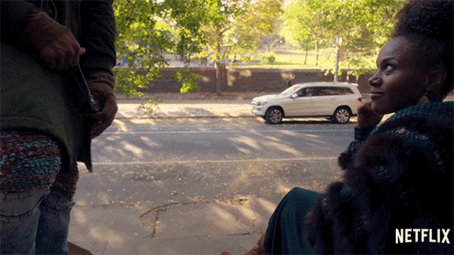 a netflix ad shows a woman sitting on the side of the road