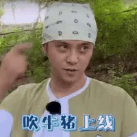 a man wearing a bandana on his head is making a funny face and pointing .