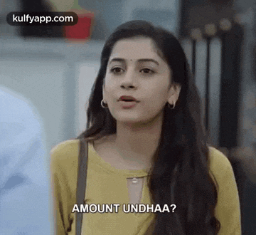 a woman in a yellow shirt is talking to a man and says `` amount undhaa ? ''