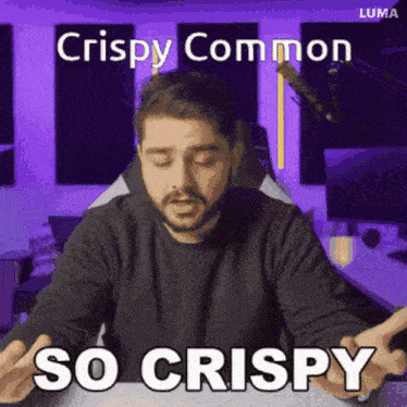 a man sitting in front of a microphone with the words crispy common so crispy on the bottom
