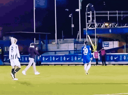 a soccer player wearing a number 20 jersey is running on the field