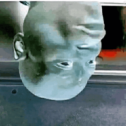 a close up of a person 's head with a reflection of another person
