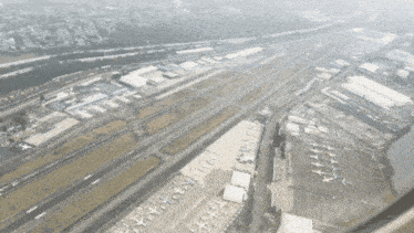 an aerial view of a runway with planes parked on it