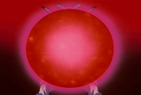 a person is holding a large red sphere in their hands
