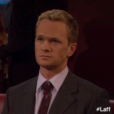a man in a suit and tie is making a middle finger gesture