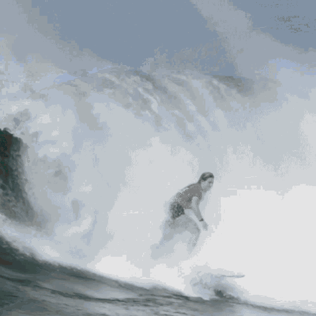 a wave is breaking in the ocean with a lot of foam coming out of it