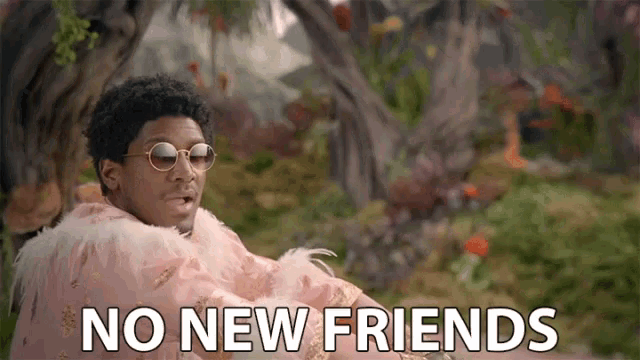 a man wearing sunglasses and a feathered cape says " no new friends "