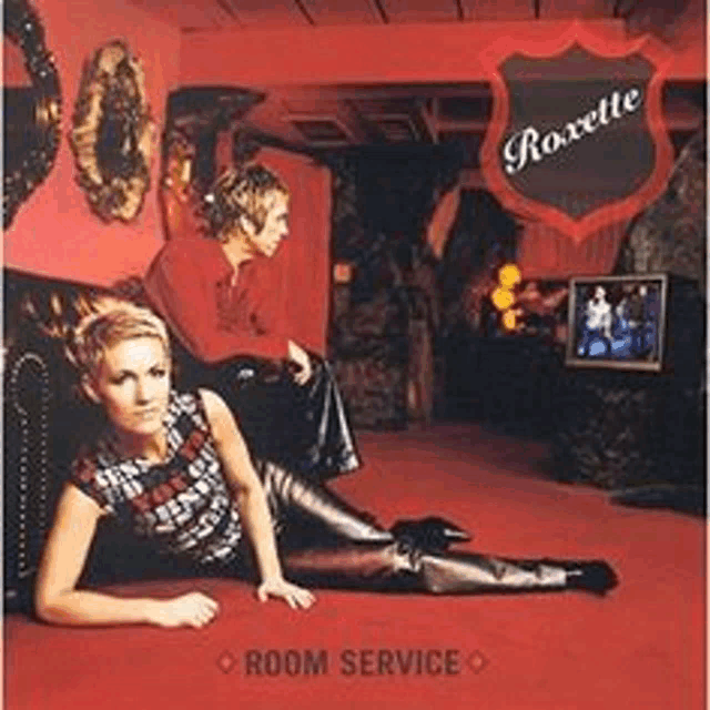 a woman is laying on the floor next to a man on a couch in a room service album cover