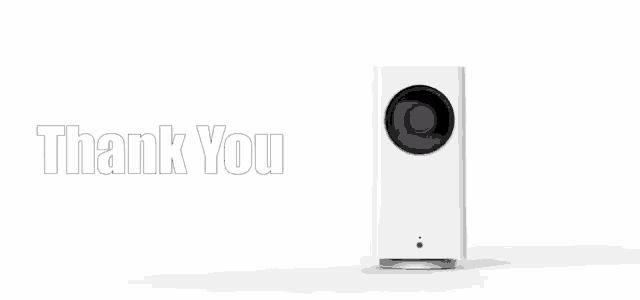a white camera is sitting on a white surface with the words thank you behind it
