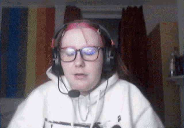 a girl wearing glasses and headphones with a microphone attached to her head