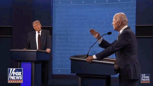 two men standing at a podium with fox news channel written on the bottom