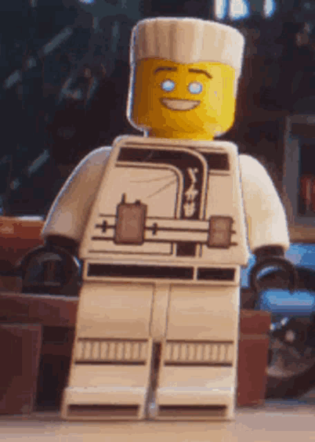 a close up of a lego figure with a yellow face and blue eyes