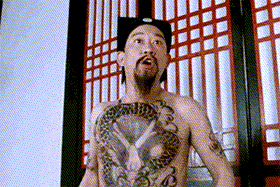 a man with a tattoo on his chest is wearing a hat