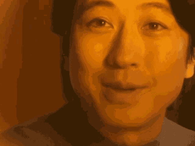 a close up of a man 's face with tears coming down his face .