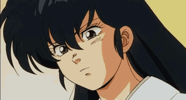 a close up of a girl 's face with a serious look on her face .