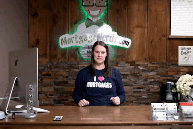 a woman wearing a shirt that says i heart mortgages