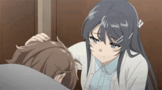 a girl is petting a boy 's head while he is laying on a bed .