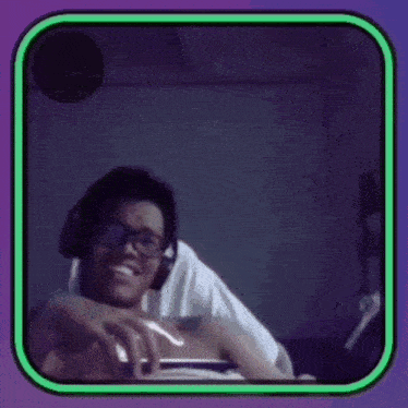a man with glasses and headphones is smiling in a green and purple frame