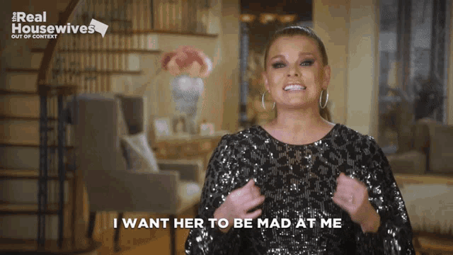 a woman says " i want her to be mad at me " while wearing a sequined dress