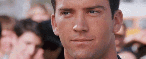 a close up of a man 's face in front of a crowd .