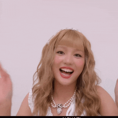 a woman wearing a pearl necklace and a headband is smiling
