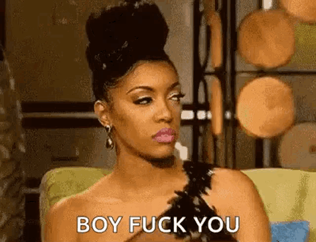 a woman in a black dress is sitting on a couch and says `` boy fuck you '' .
