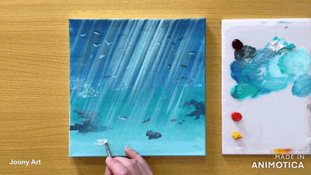 a painting is being painted on a wooden table with the words made in animatica on the bottom