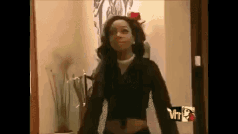 a woman is standing in a doorway with a vh1 logo in the background