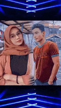 a man in a hugo shirt stands next to a woman