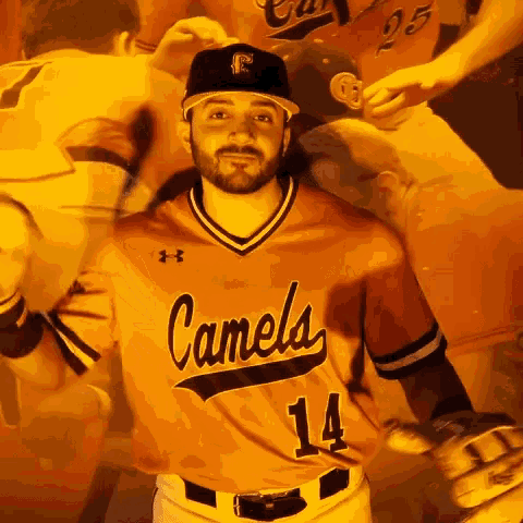 a man wearing a camels jersey with the number 14 on it