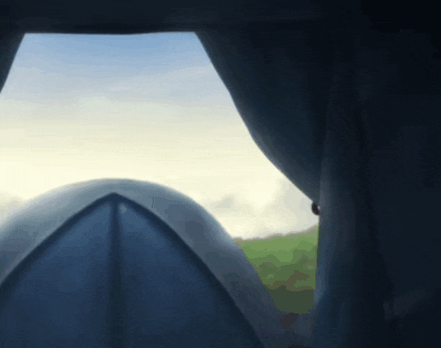 a view of a tent from a window with a cloudy sky in the background