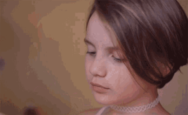 a young girl wearing headphones is listening to music