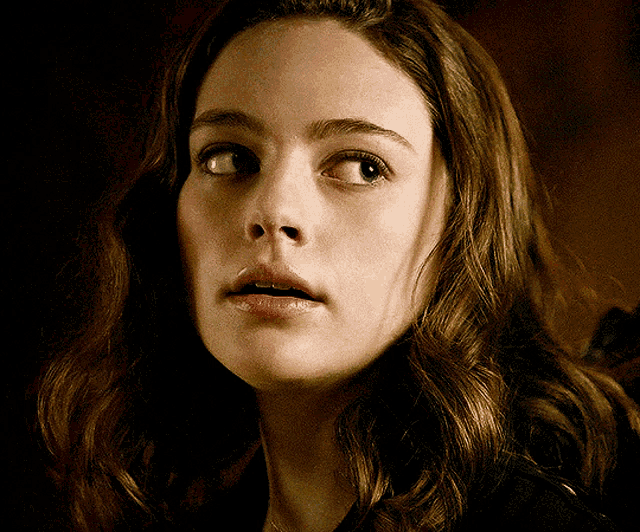 a close up of a woman 's face with brown hair