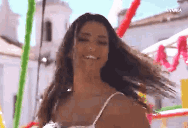 a woman in a white tank top is smiling with vivavida written on the bottom