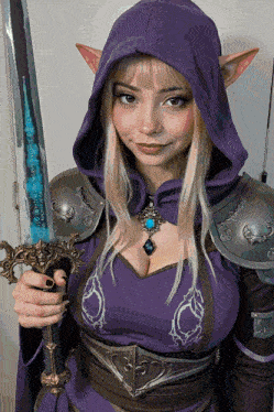 a woman in a purple hooded dress holds a sword