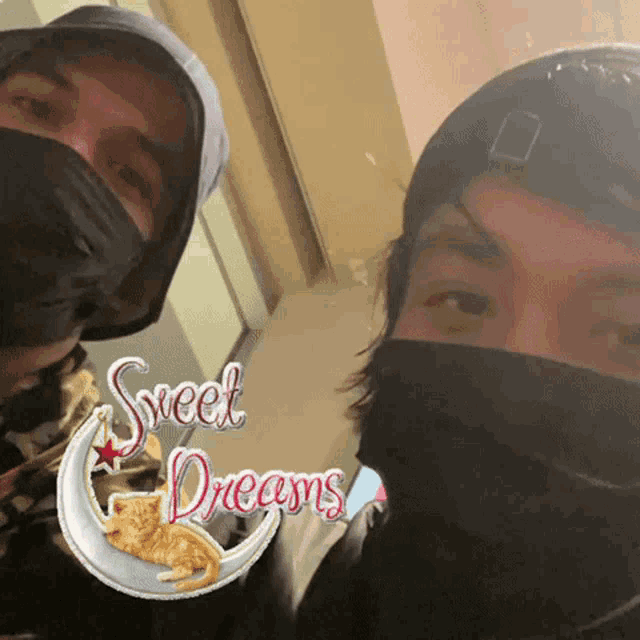 two people wearing face masks with a sweet dreams sticker on the bottom